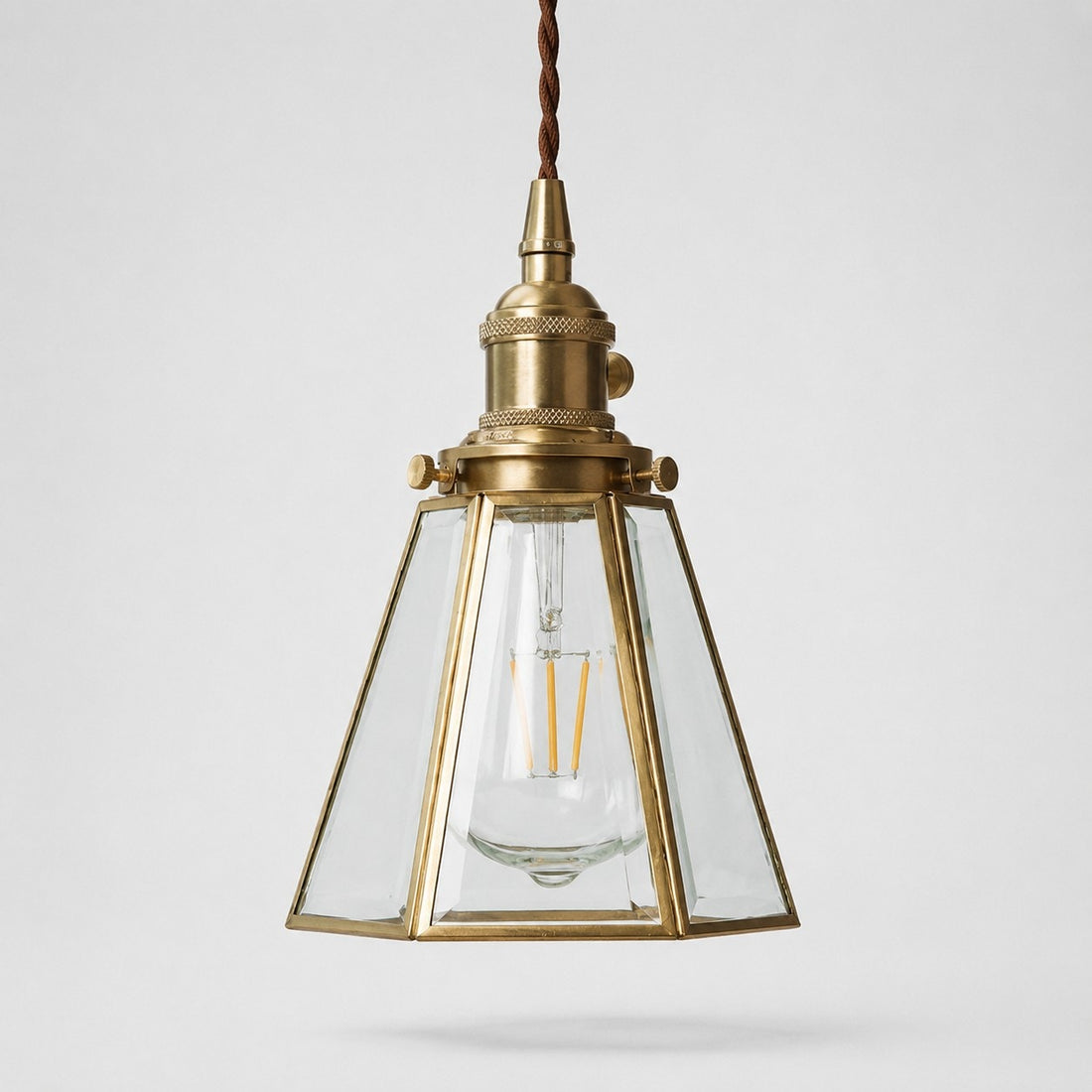 Clear glass pendant light with brass canopy
