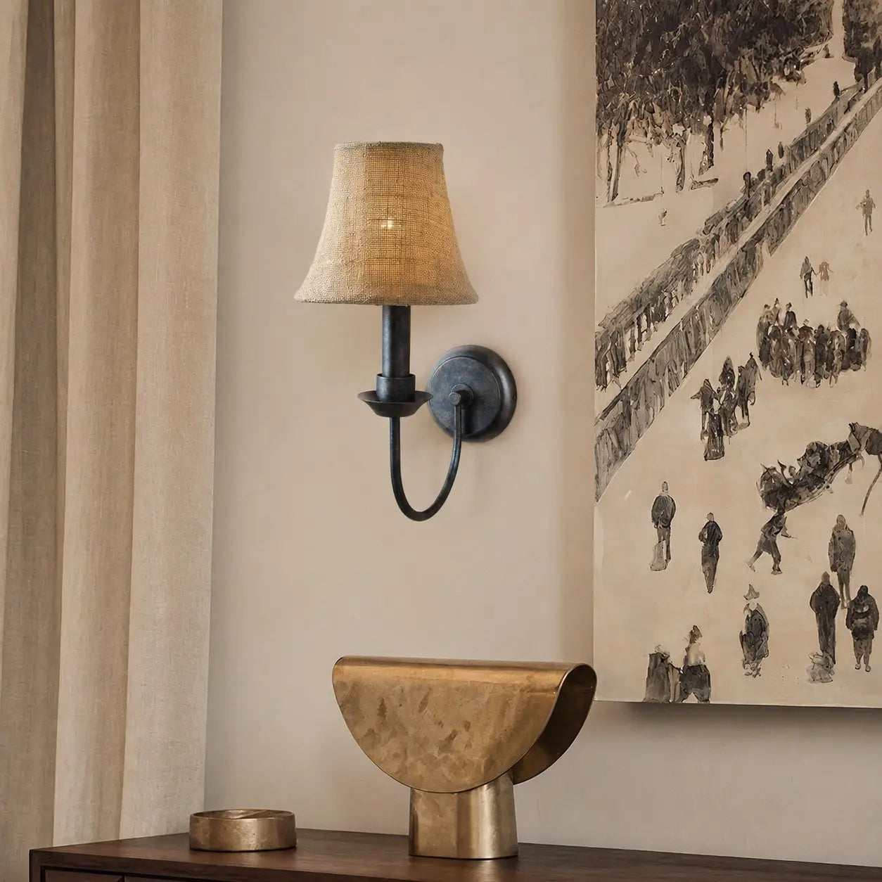 Fabric wall sconce beside framed wall art