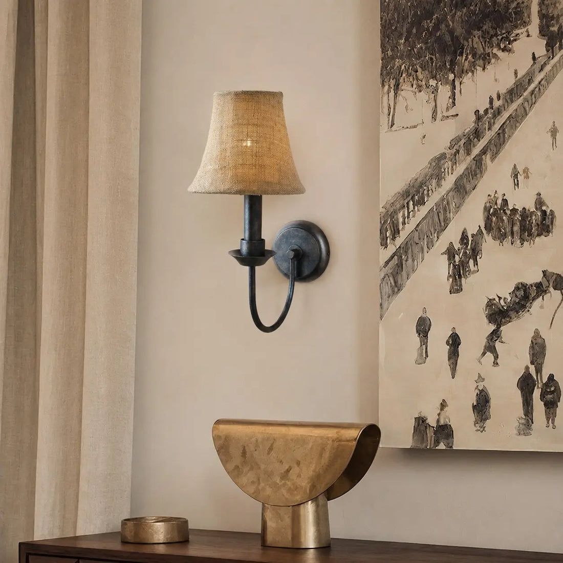 Fabric wall sconce beside framed wall art
