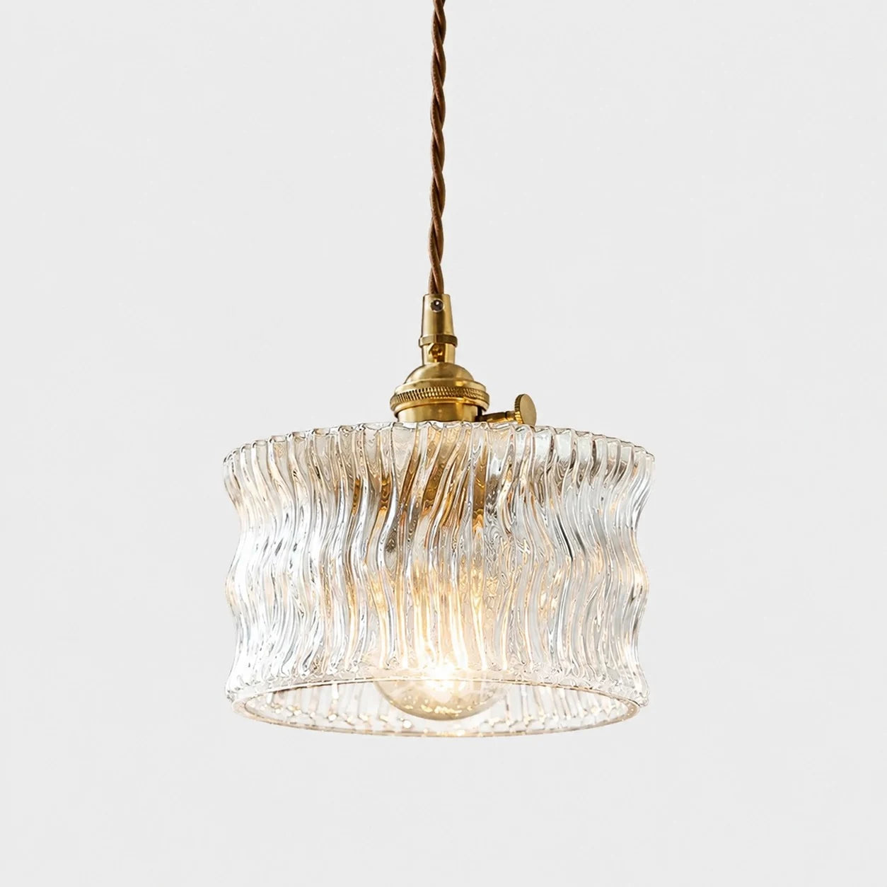Clear ripple glass ceiling pendant with warm bulb