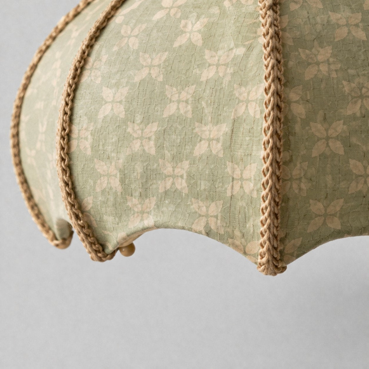 Sage floral fabric shade curved edge and trim detail