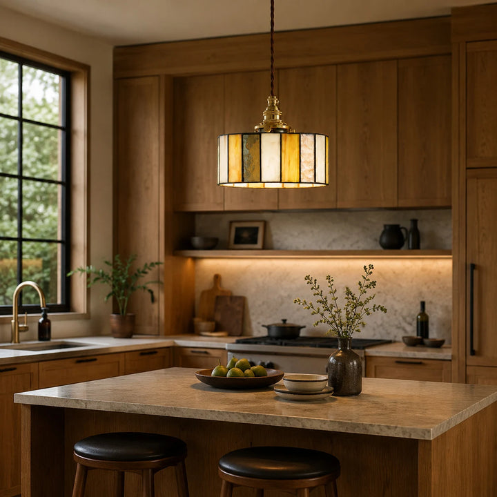 Stained glass pendant light above a warm wood kitchen island