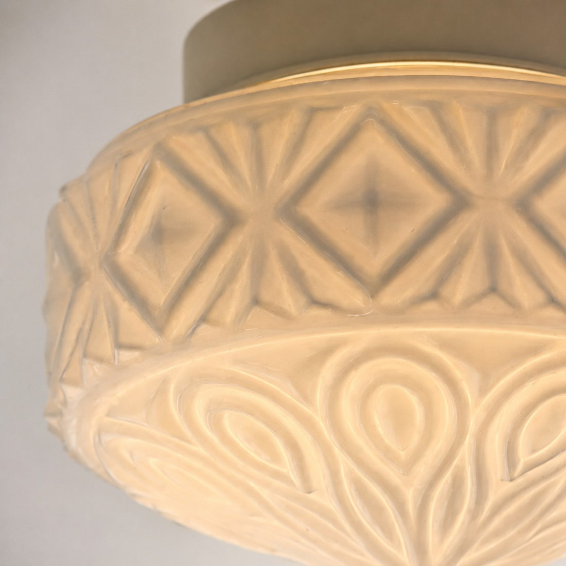 Warm close-up of embossed glass ceiling light pattern
