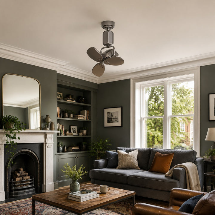 Compact ceiling fan in a green living room with sofa and fireplace