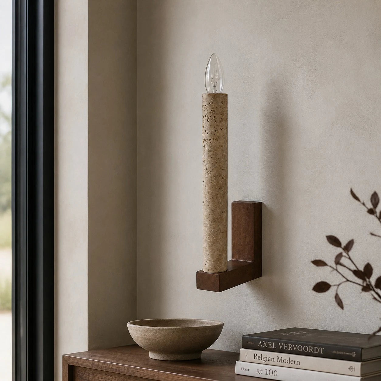 Natural travertine wall sconce above an entry console