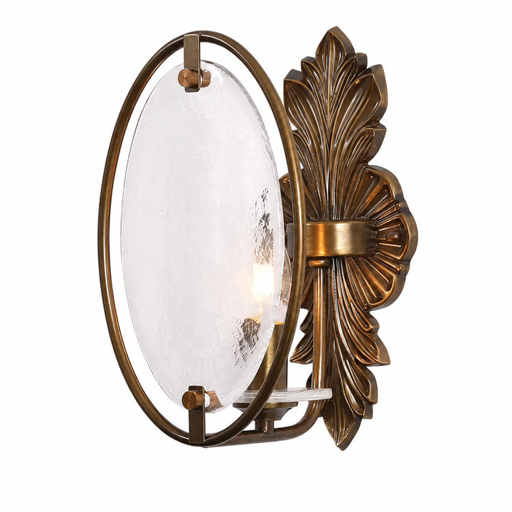 Side view of antique brass wall sconce with oval textured glass shade