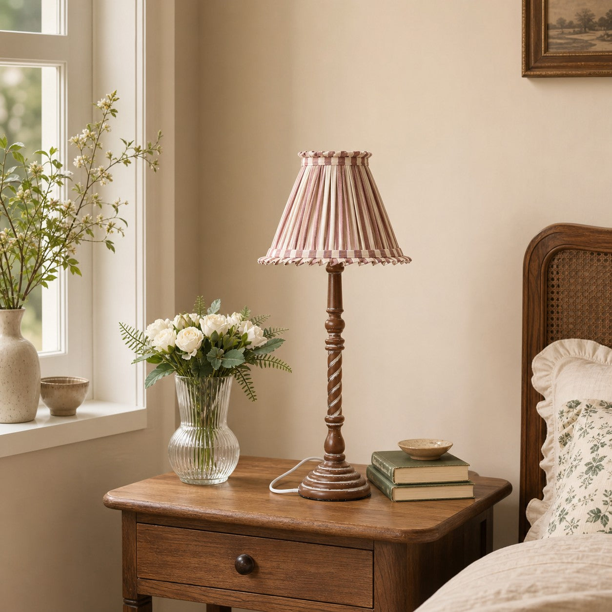 Pink striped pleated table lamp on bedroom nightstand
