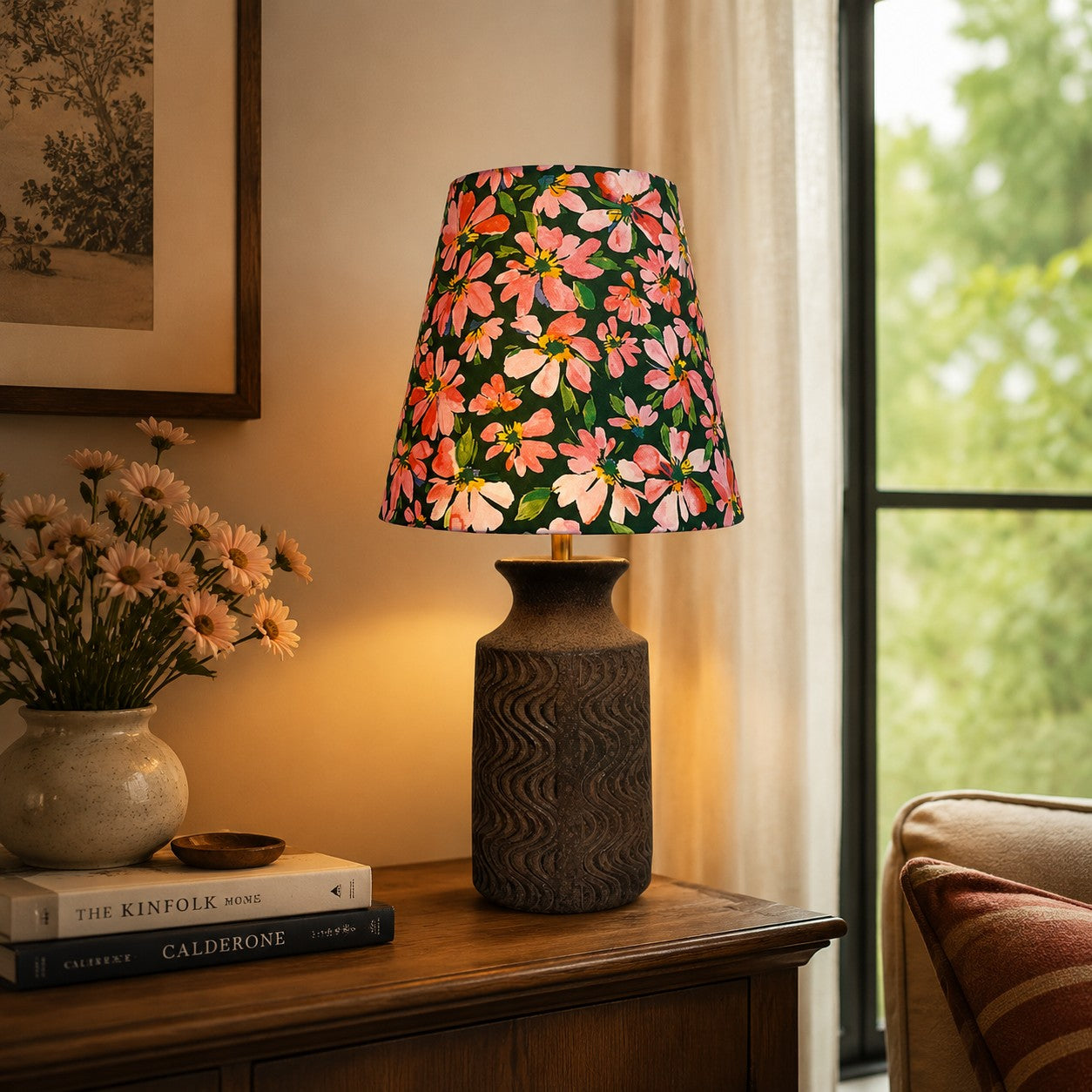Floral ceramic table lamp illuminating a vintage console by a window