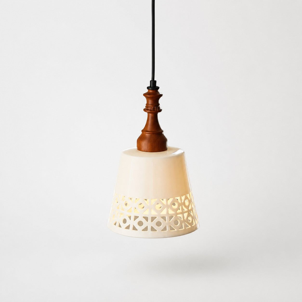cutout ceramic shade pendant light on gray background