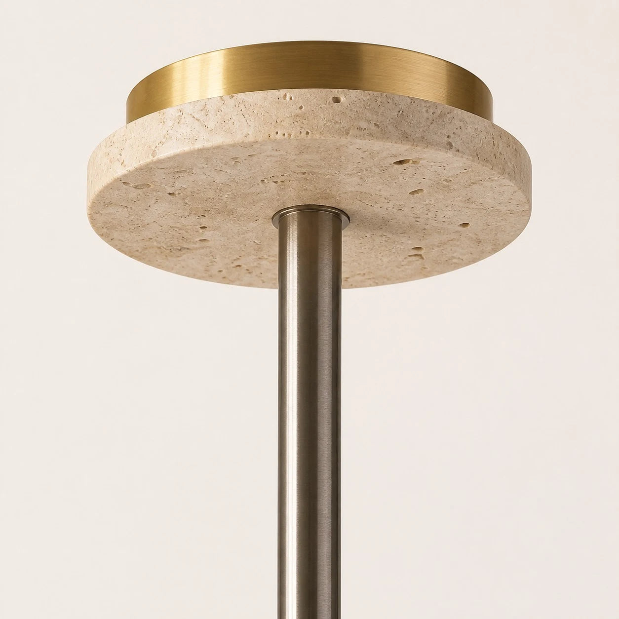 Close view of the travertine ceiling canopy and metal suspension rod