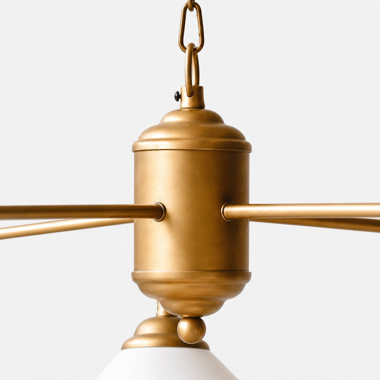 Antiqued brass-tone center body and curved chandelier arms