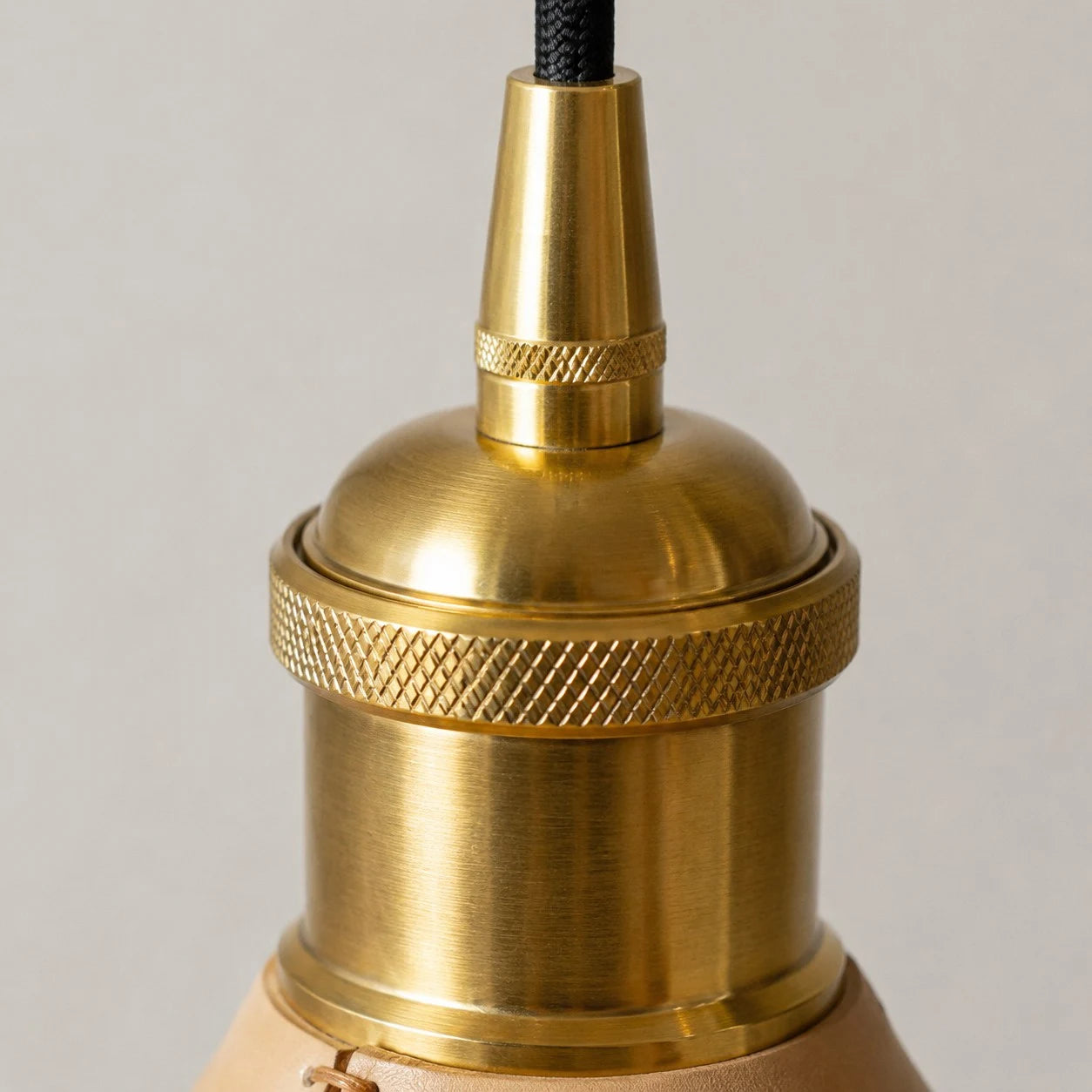 Brass tone cap and hanging cord detail