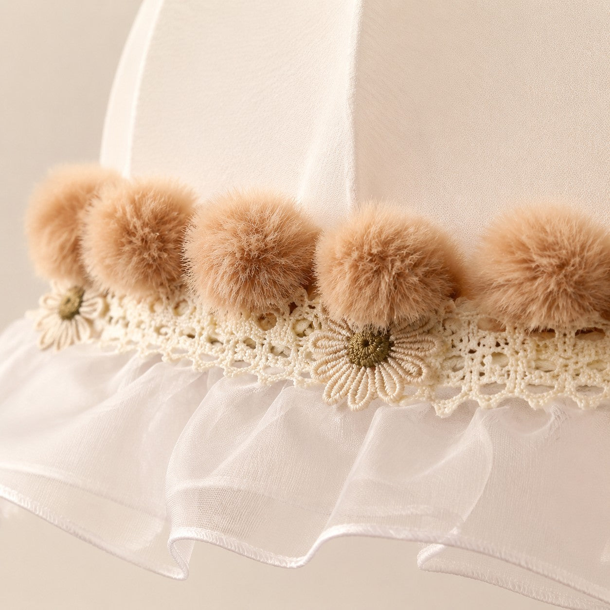 Warm camel pom-pom trim and floral lace detail