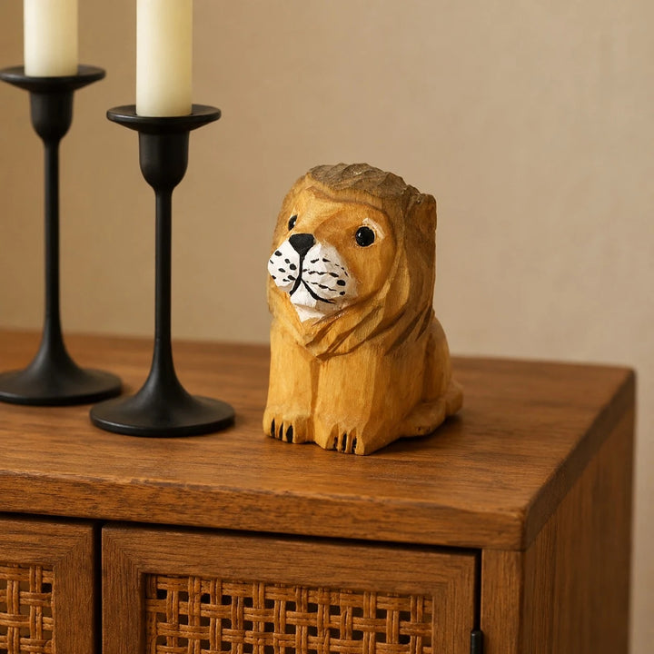 Wooden lion figurine styled on a cabinet