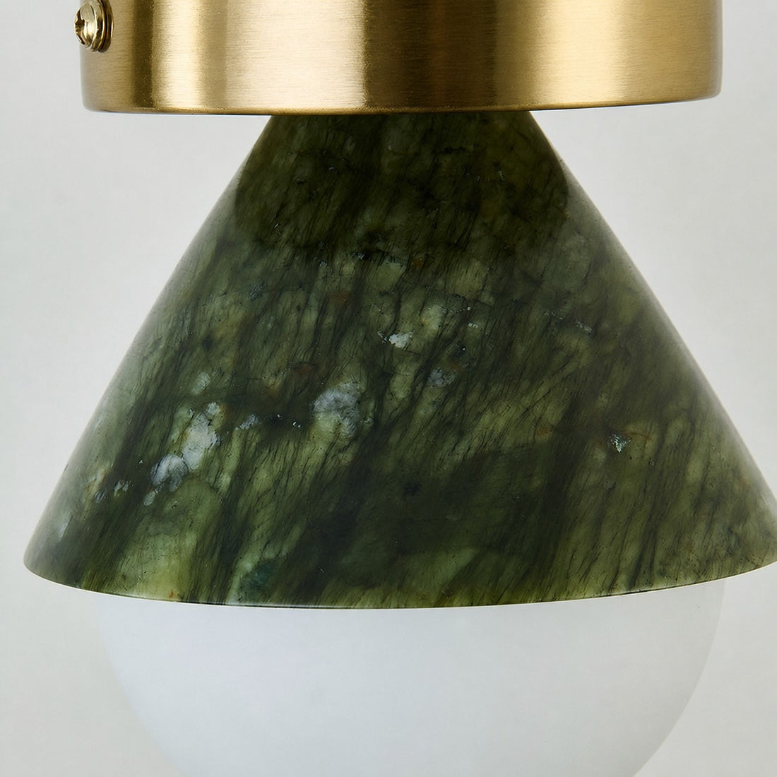 Close-up of green jade-style shade and brushed metal canopy