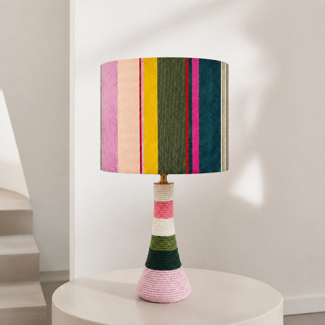 Colorful striped table lamp on a round side table
