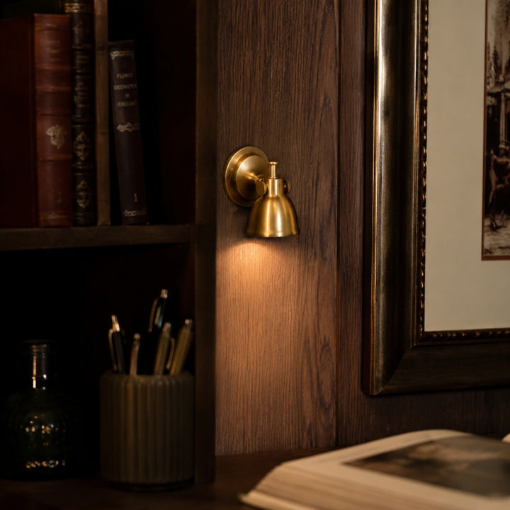 Brass wall lamp installed in a warm interior