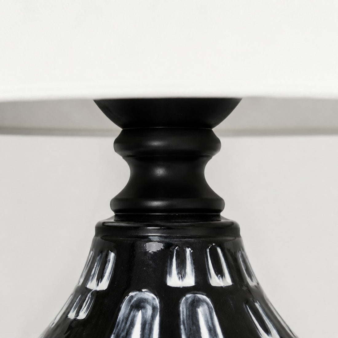 Glossy black ceramic neck detail on table lamp