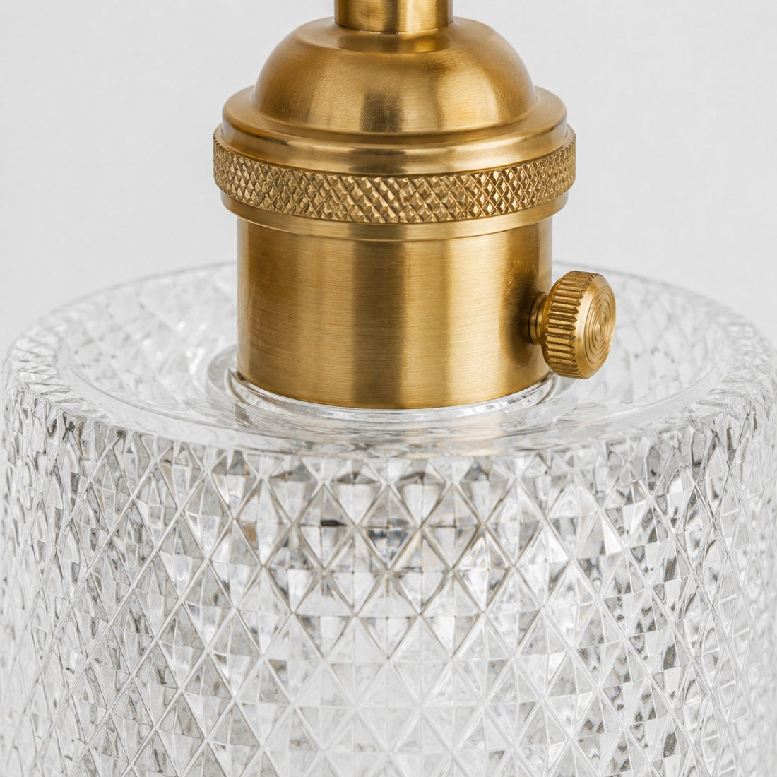 Close view of brass support arm and glass shade connection