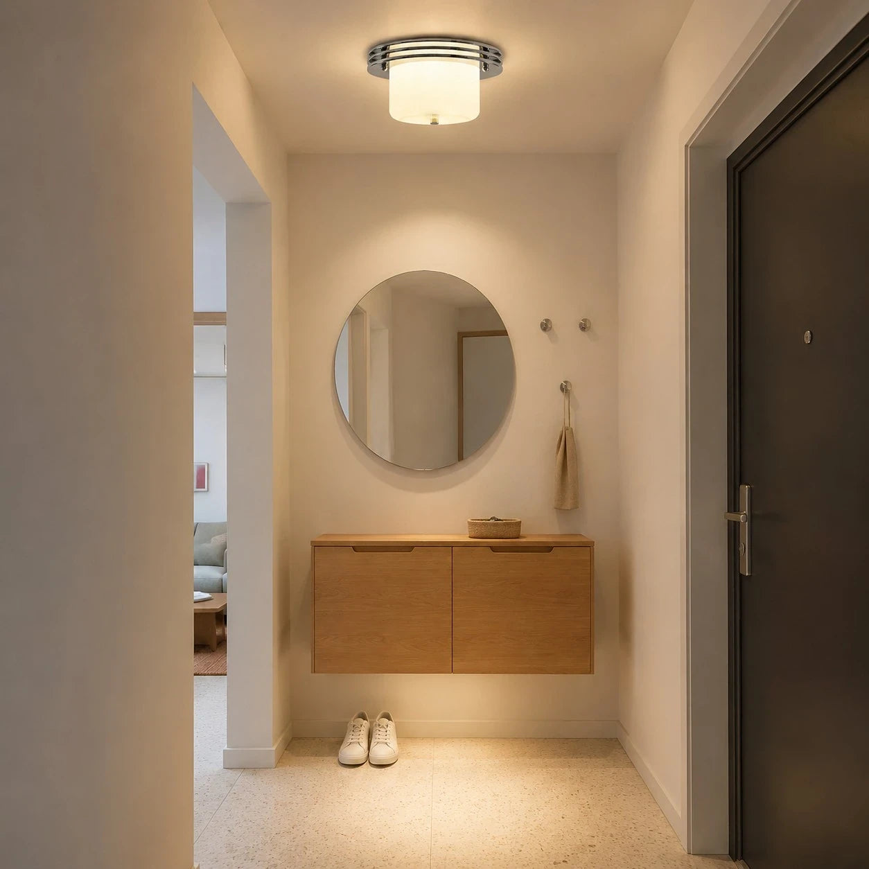 Chrome and milky white flush mount ceiling fixture installed in a compact entry area