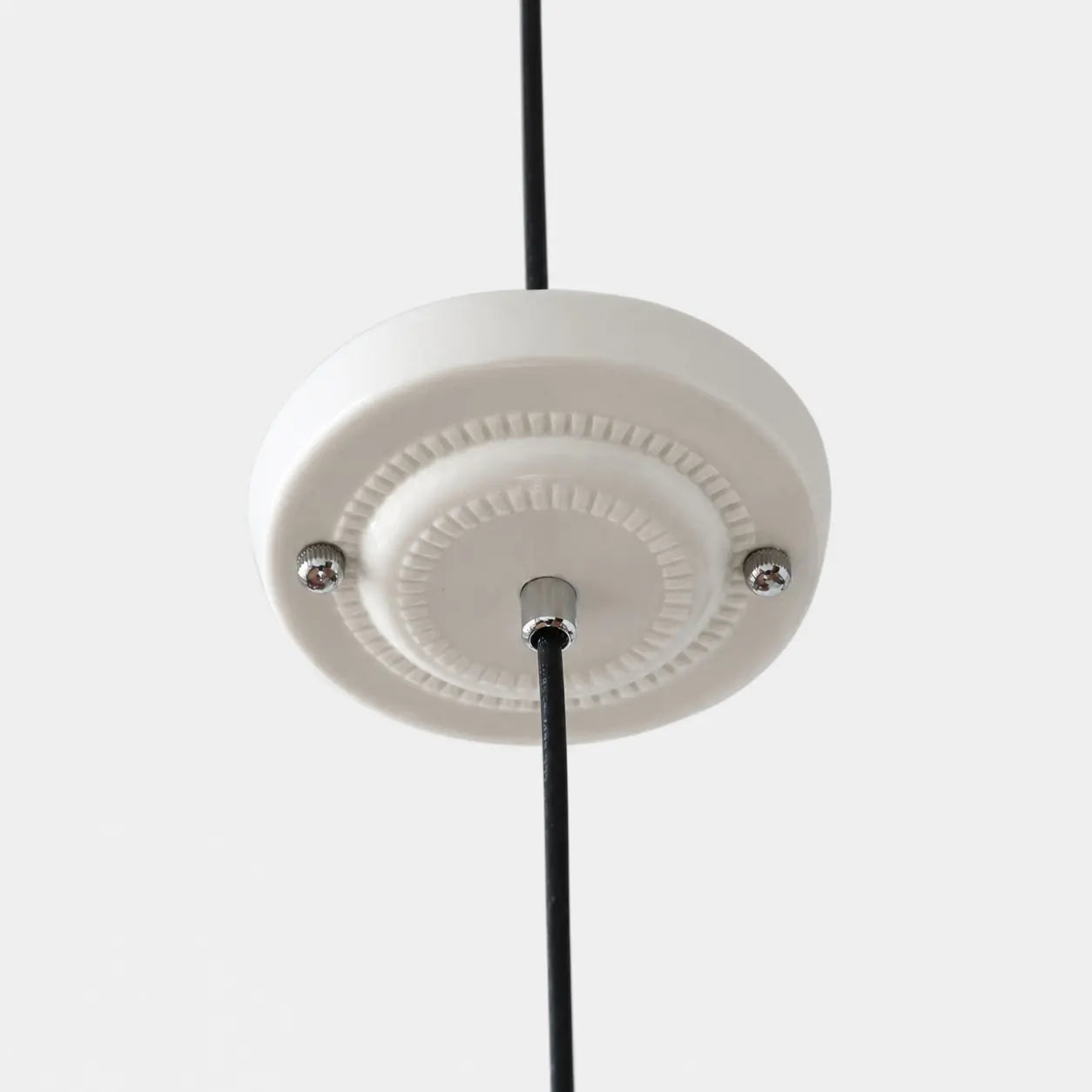 Close view of the ceiling canopy and cord connection