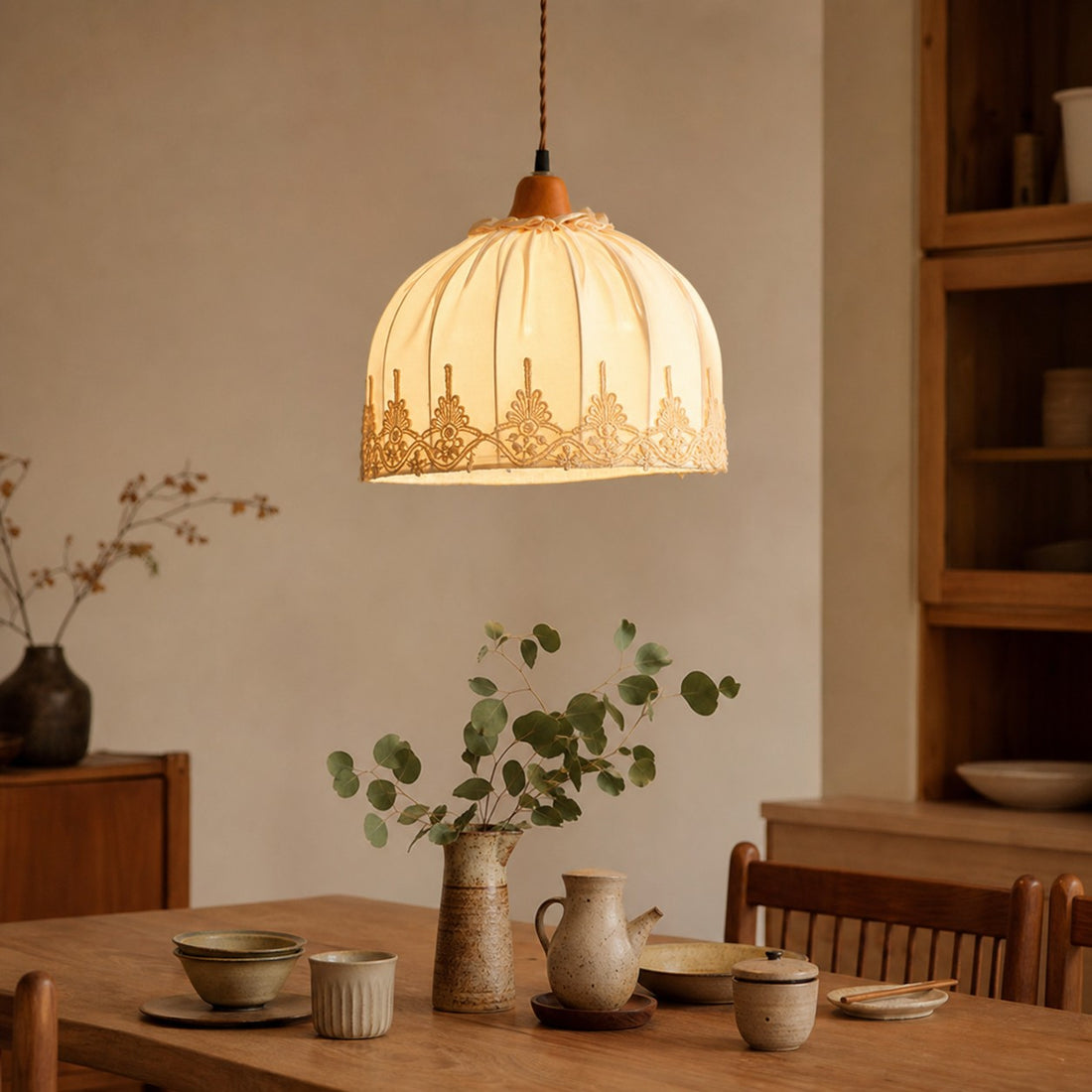 Vintage lace fabric pendant light above a dining table