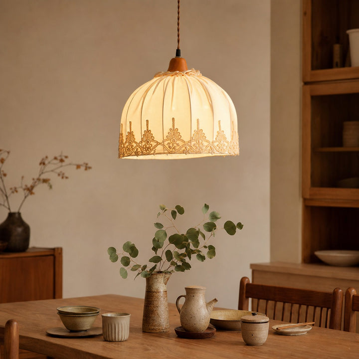 Vintage lace fabric pendant light above a dining table
