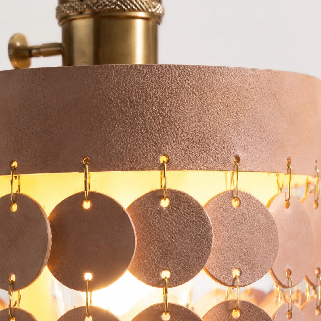 Close view of textured leather discs and metal links