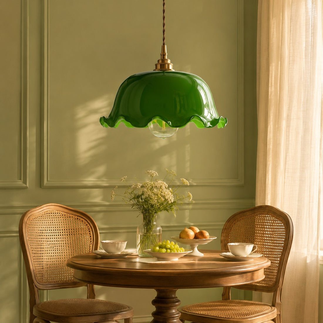 Wavy green glass pendant light over a round dining table