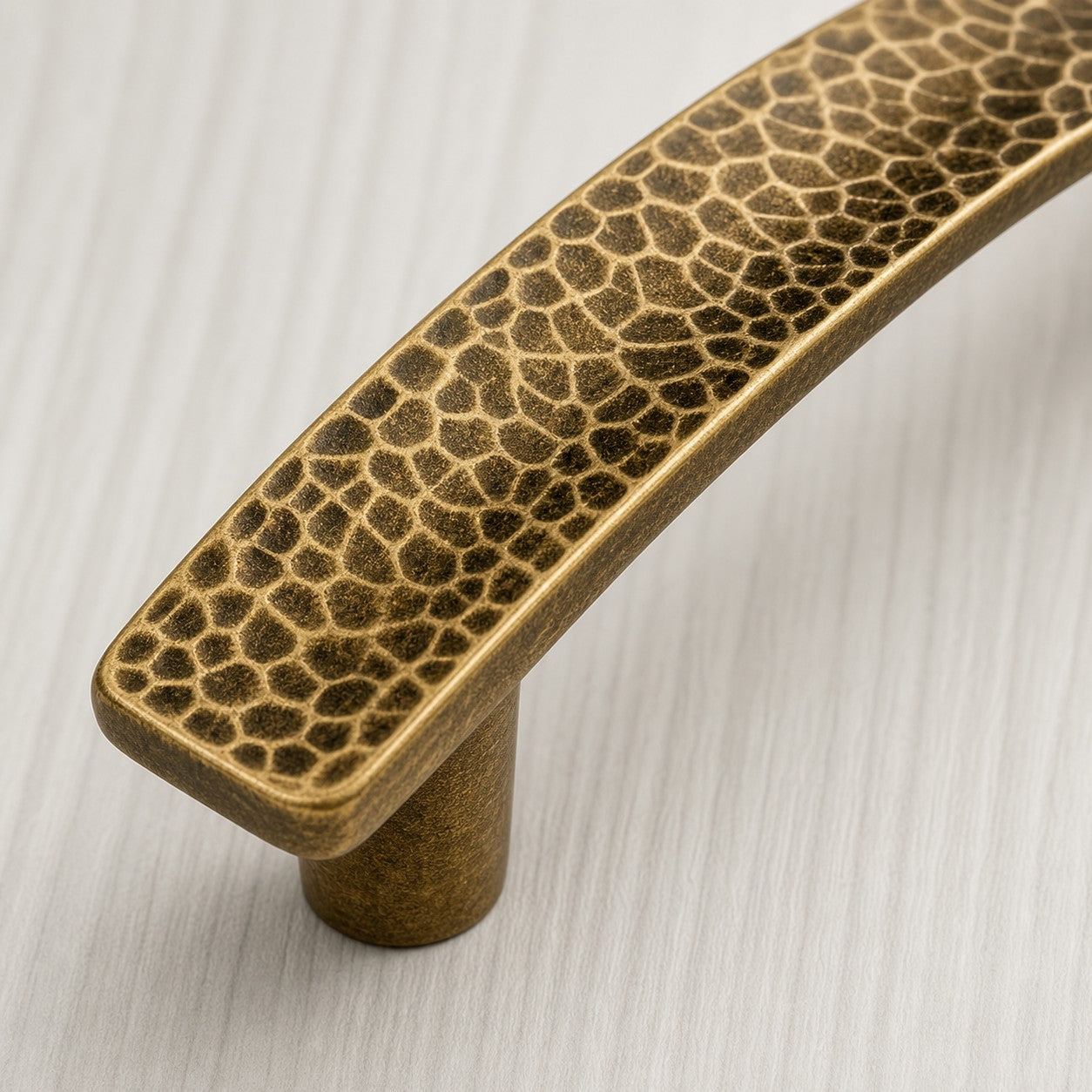 Close-up of hammered brass cabinet pull finish