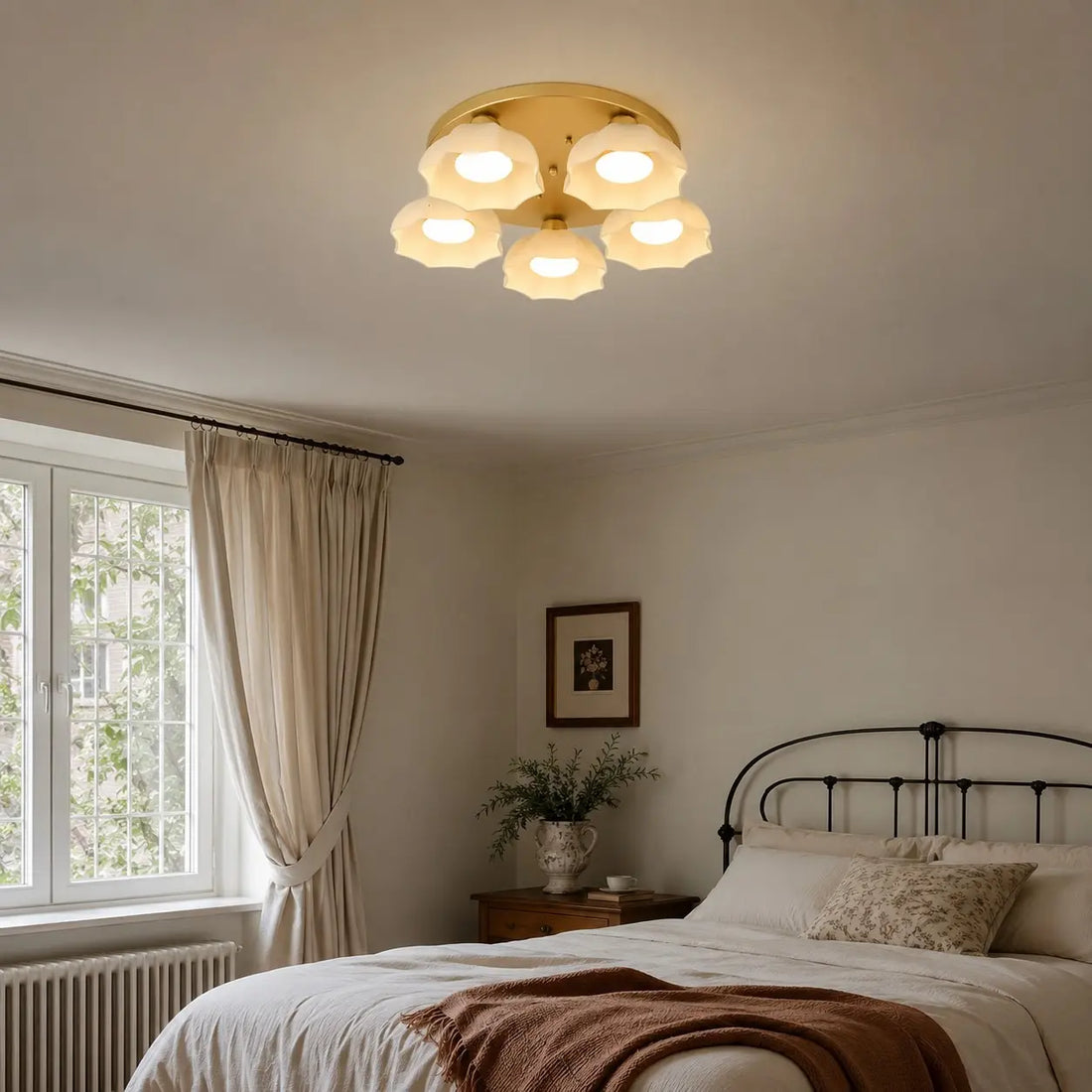 Modern bedroom with a gold and white glass ceiling light