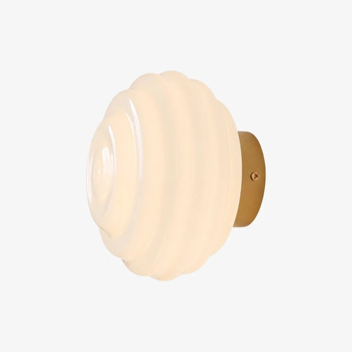 White ribbed glass wall sconce with brass finish