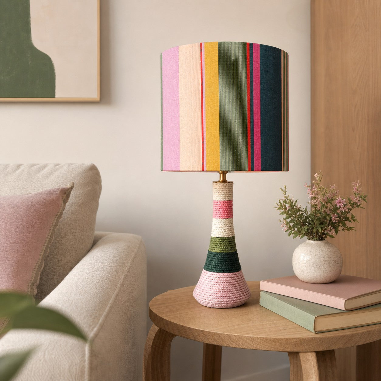 Colorful striped ceramic table lamp with cotton thread wrapped exterior in a cozy living room corner