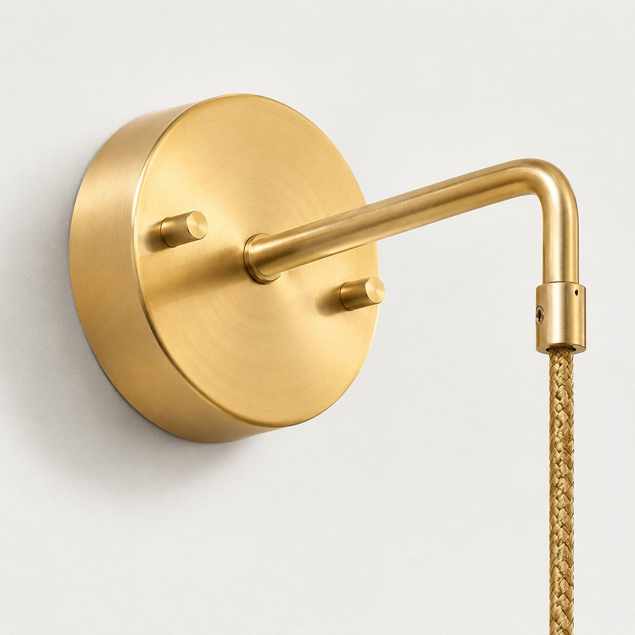 Round brass wall plate and arm connection detail