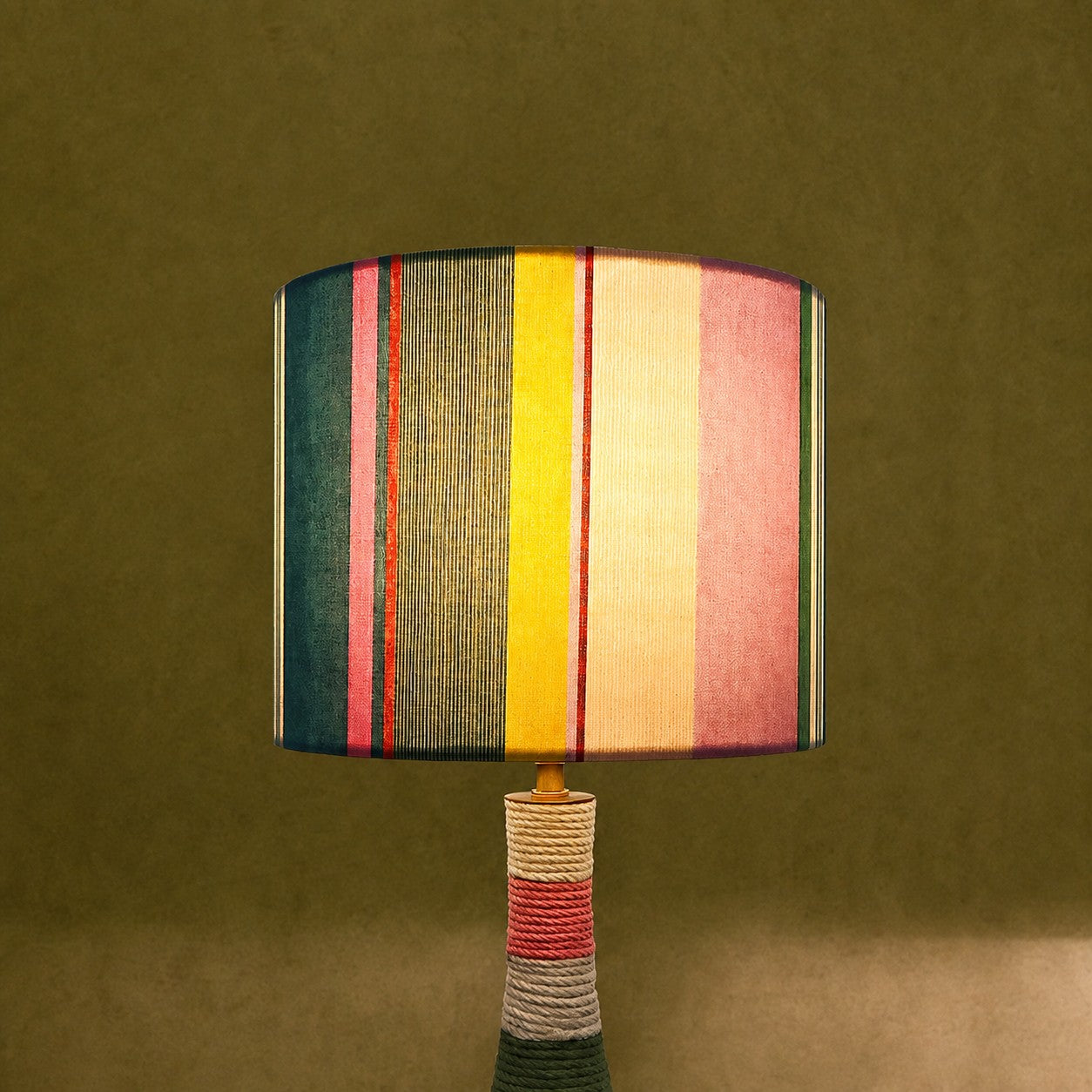 Colorful striped table lamp switched on with warm ambient light