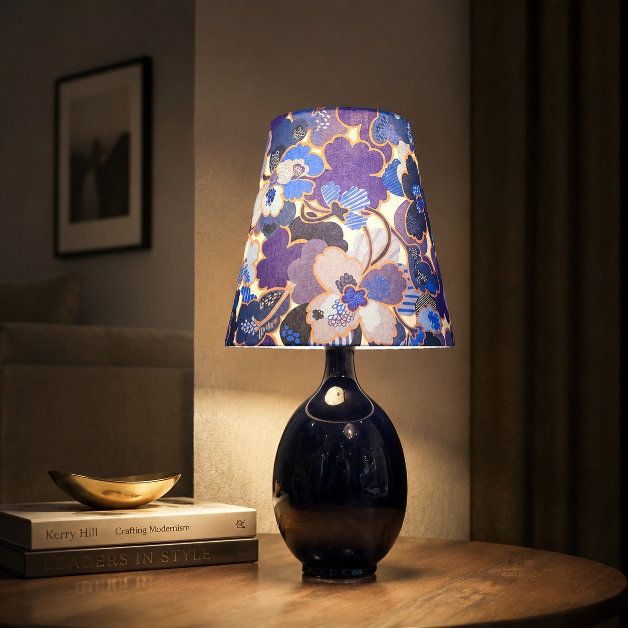 Blue floral fabric ceramic table lamp on a bedside table