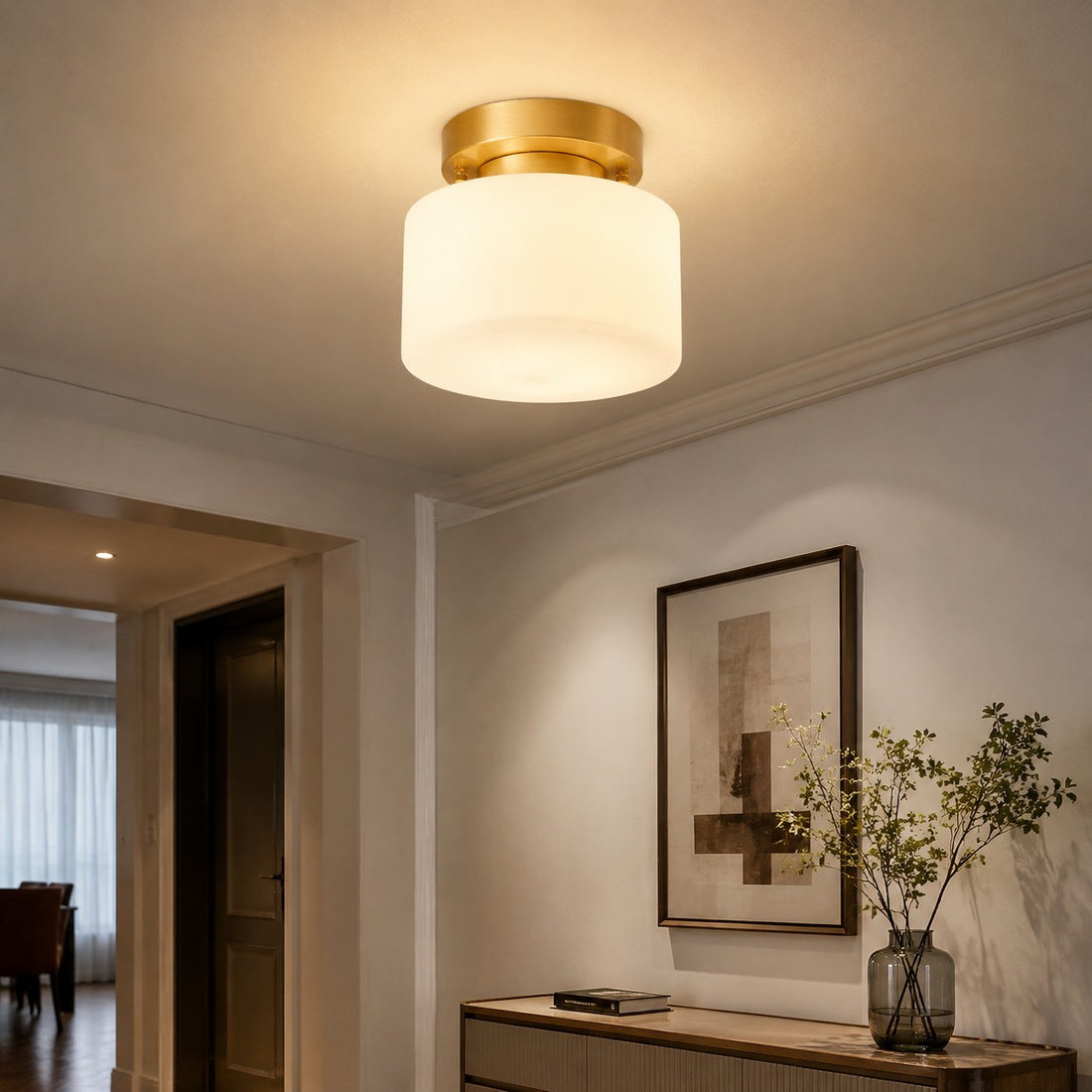 Warm ceiling light in a hallway with wall art