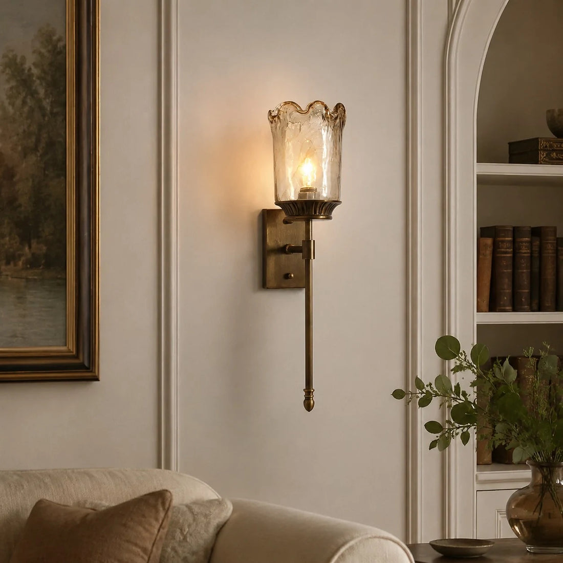 Brass amber glass wall sconce in a living room corner