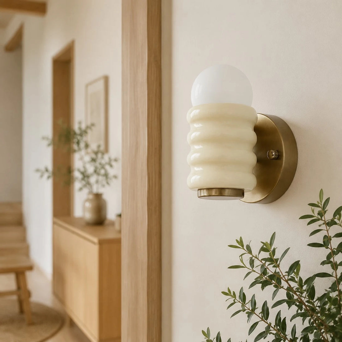 Cream wall sconce in hallway