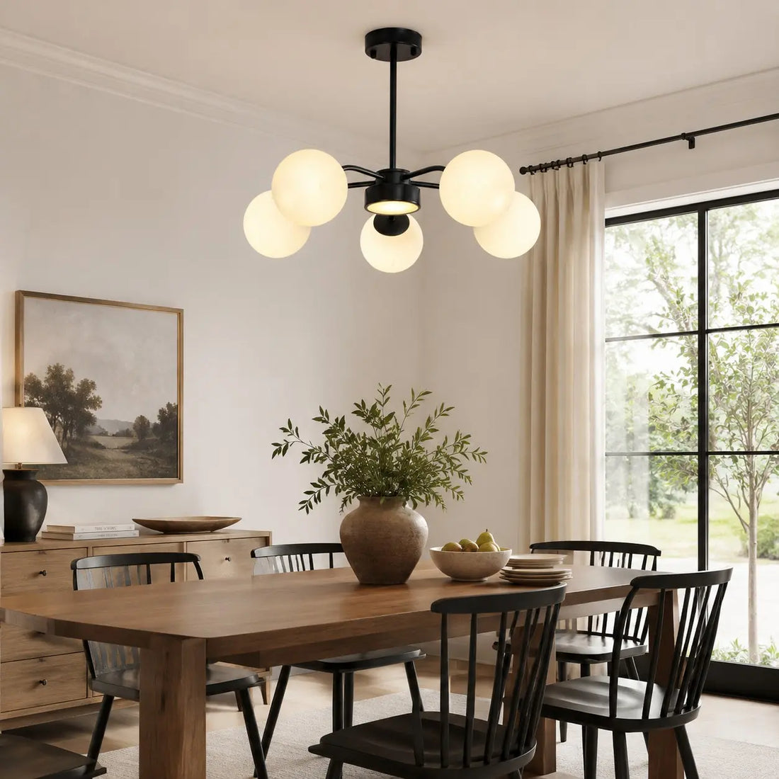 Black five-light chandelier above a dining table