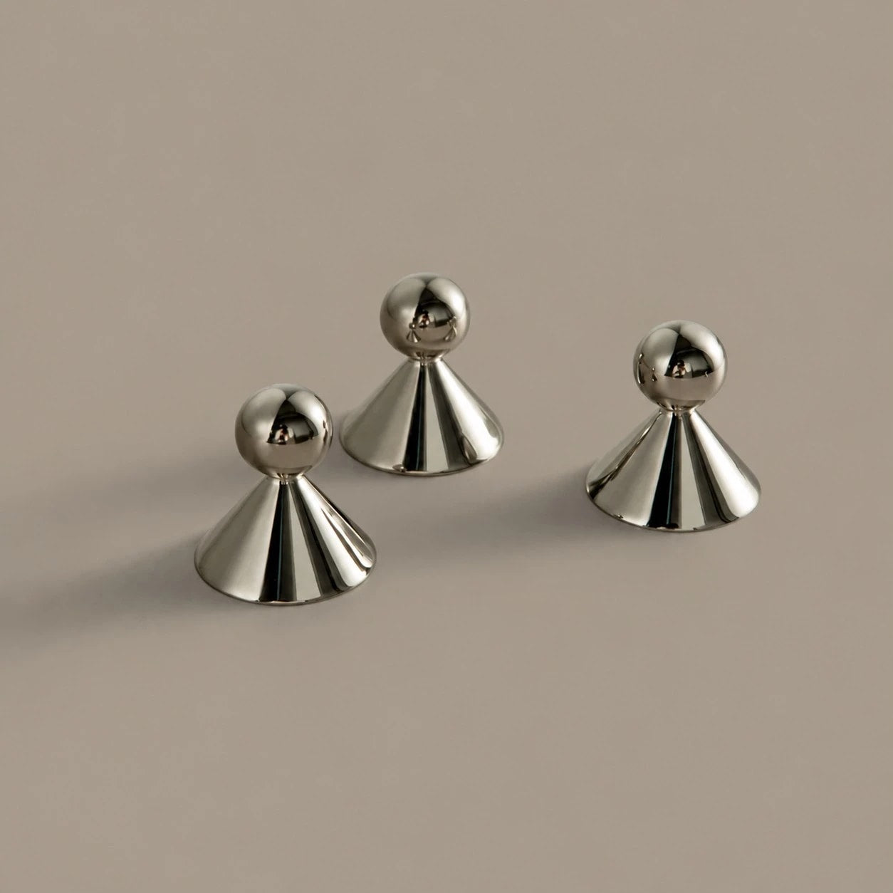 Sculptural brass cabinet knobs shown from several angles