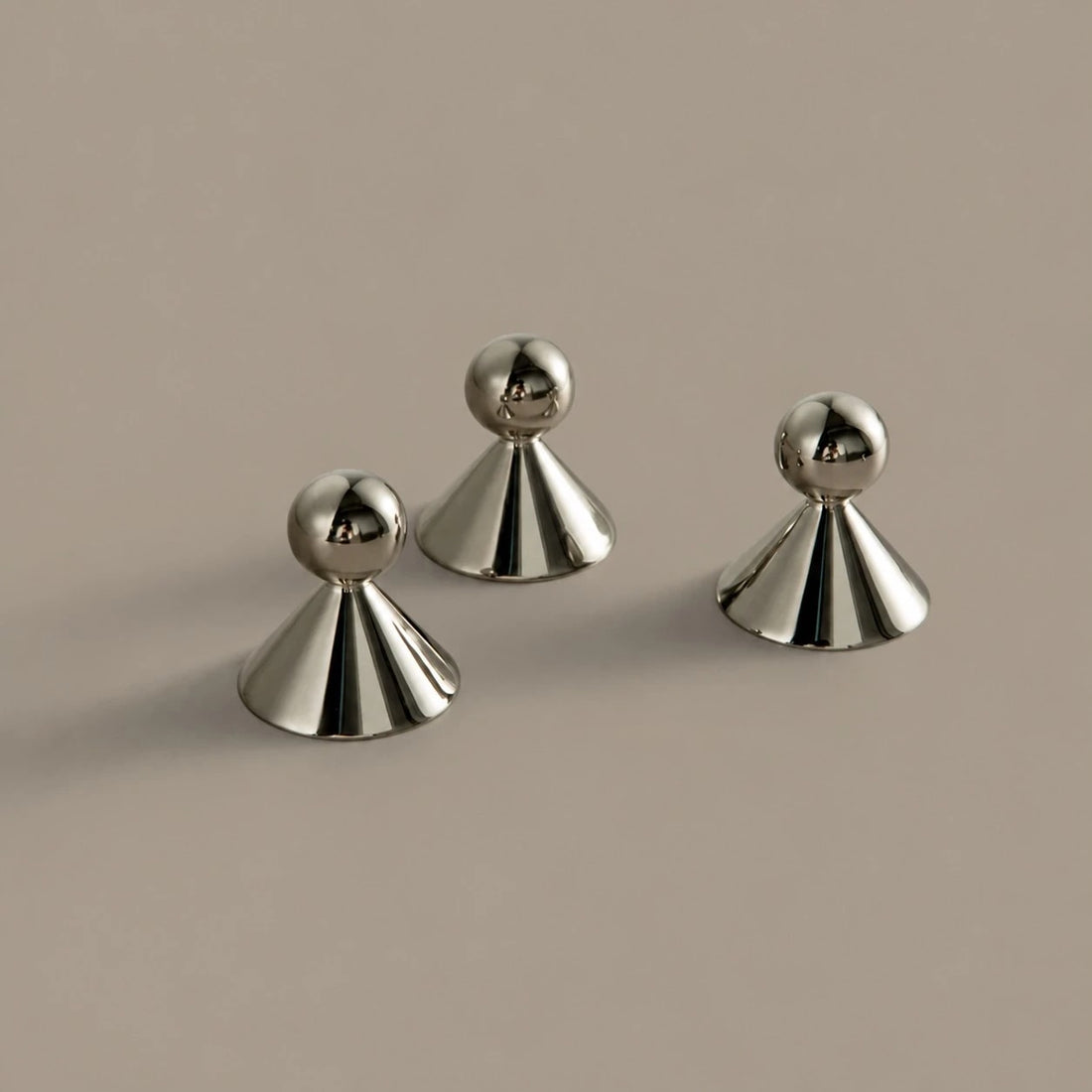 Sculptural brass cabinet knobs shown from several angles