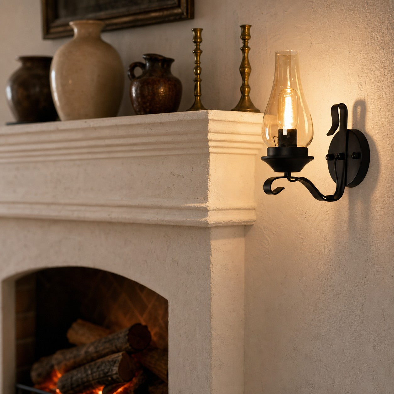 Kerosene style wall lamp glowing beside a fireplace mantel