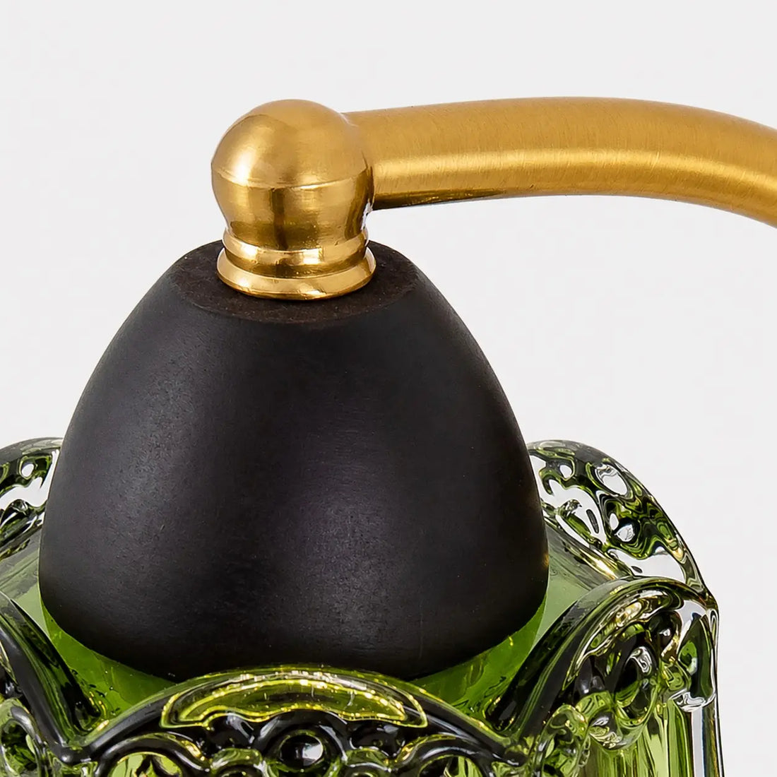 Brass-toned arm and dark lamp holder detail