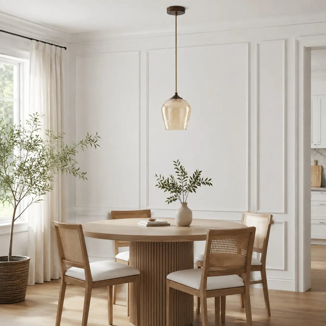 Amber glass pendant light above a dining table