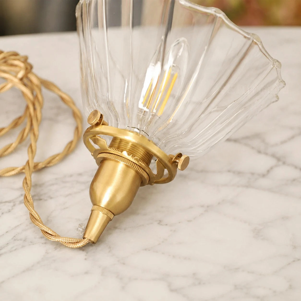 Brass-tone hardware and ribbed glass detail