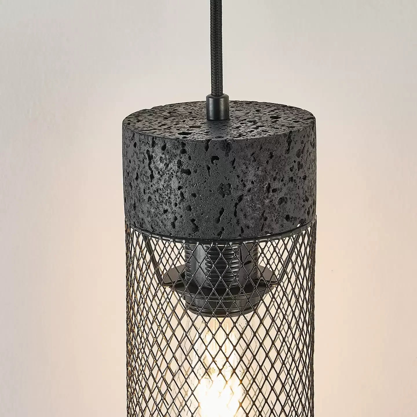 Close view of black stone top, mesh shade, and warm light