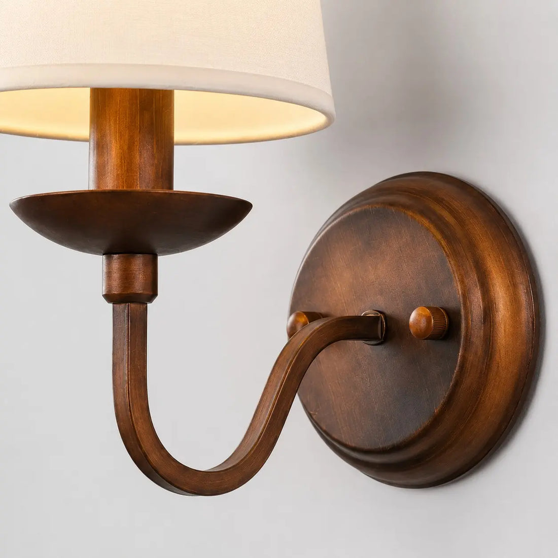 Close view of the curved arm and antique bronze finish