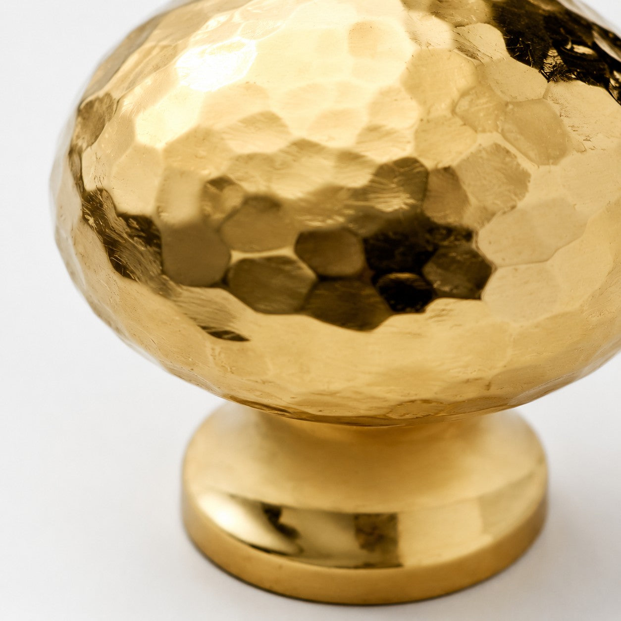 Close view of the hammered Natural Brass mushroom knob and polished base