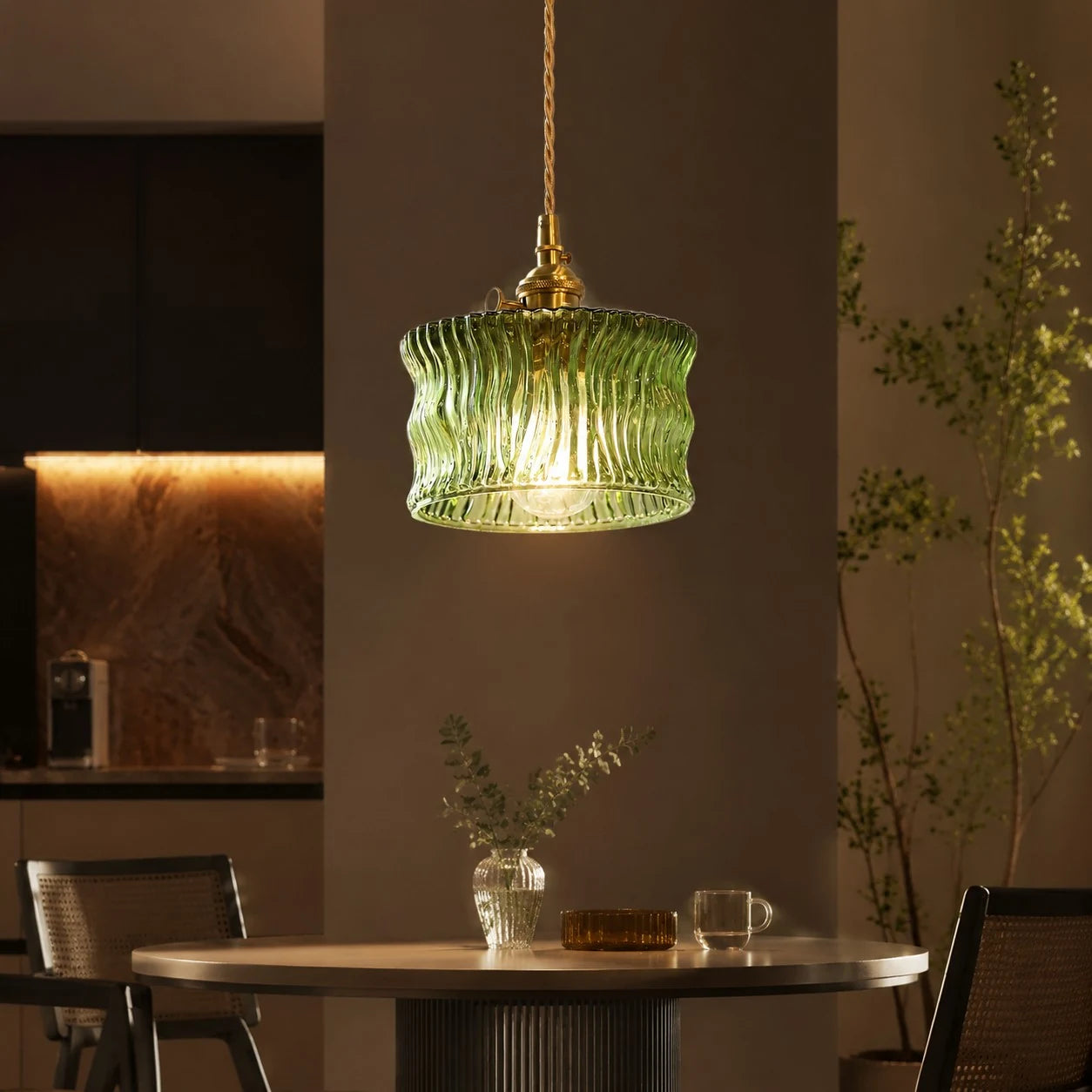 Olive green ripple glass pendant above a counter